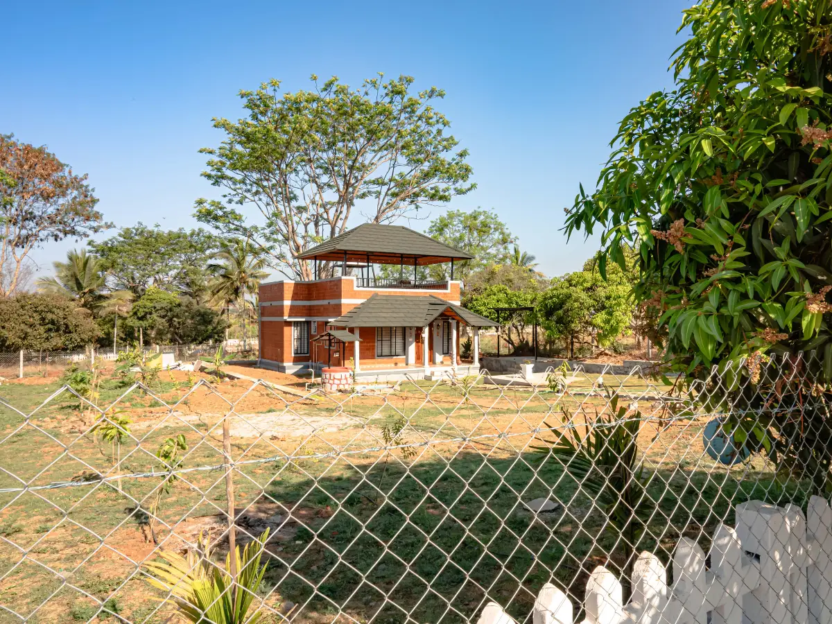 Farmhouse with open land view inside Vasudha Kalpataru farmland