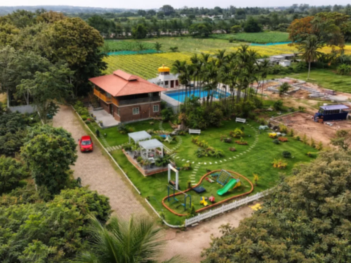 Full view of Vasudha Kalpataru farmland project with green landscape and modern amenities